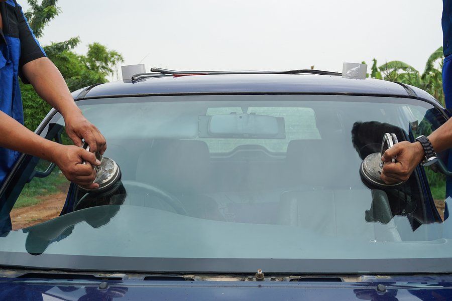 two people repairing the windshield
