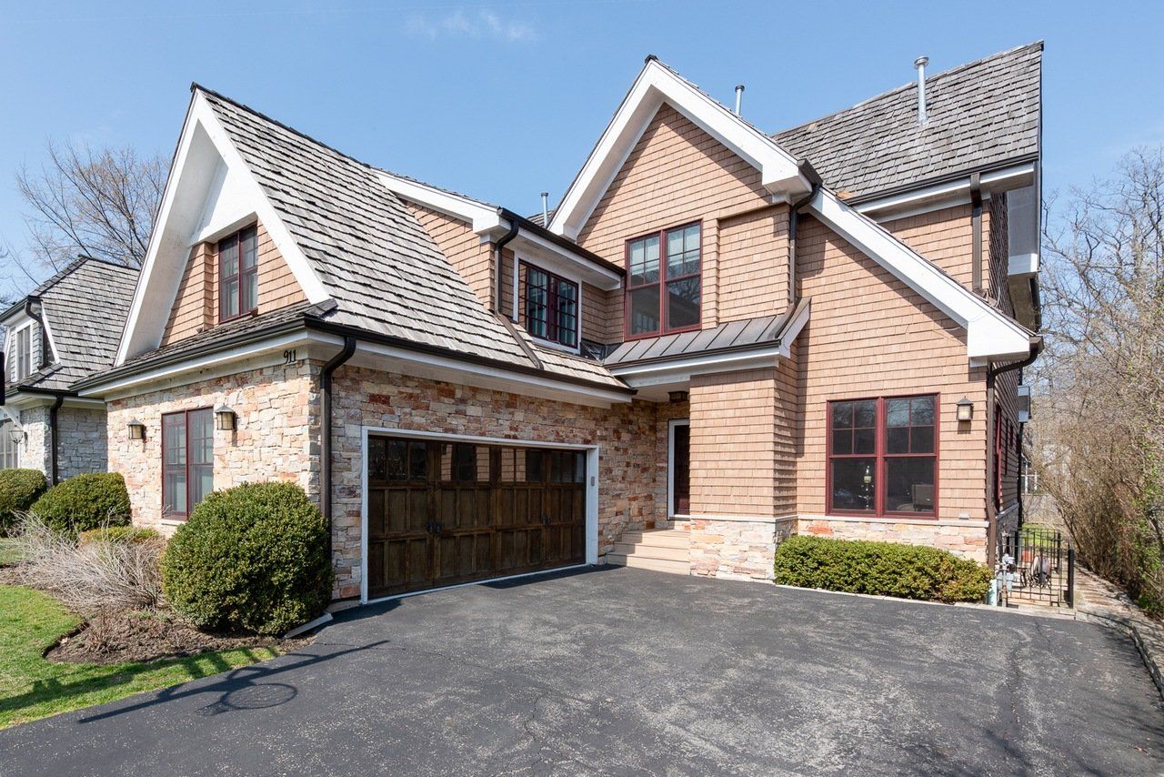 A large brick house with a garage and a driveway
