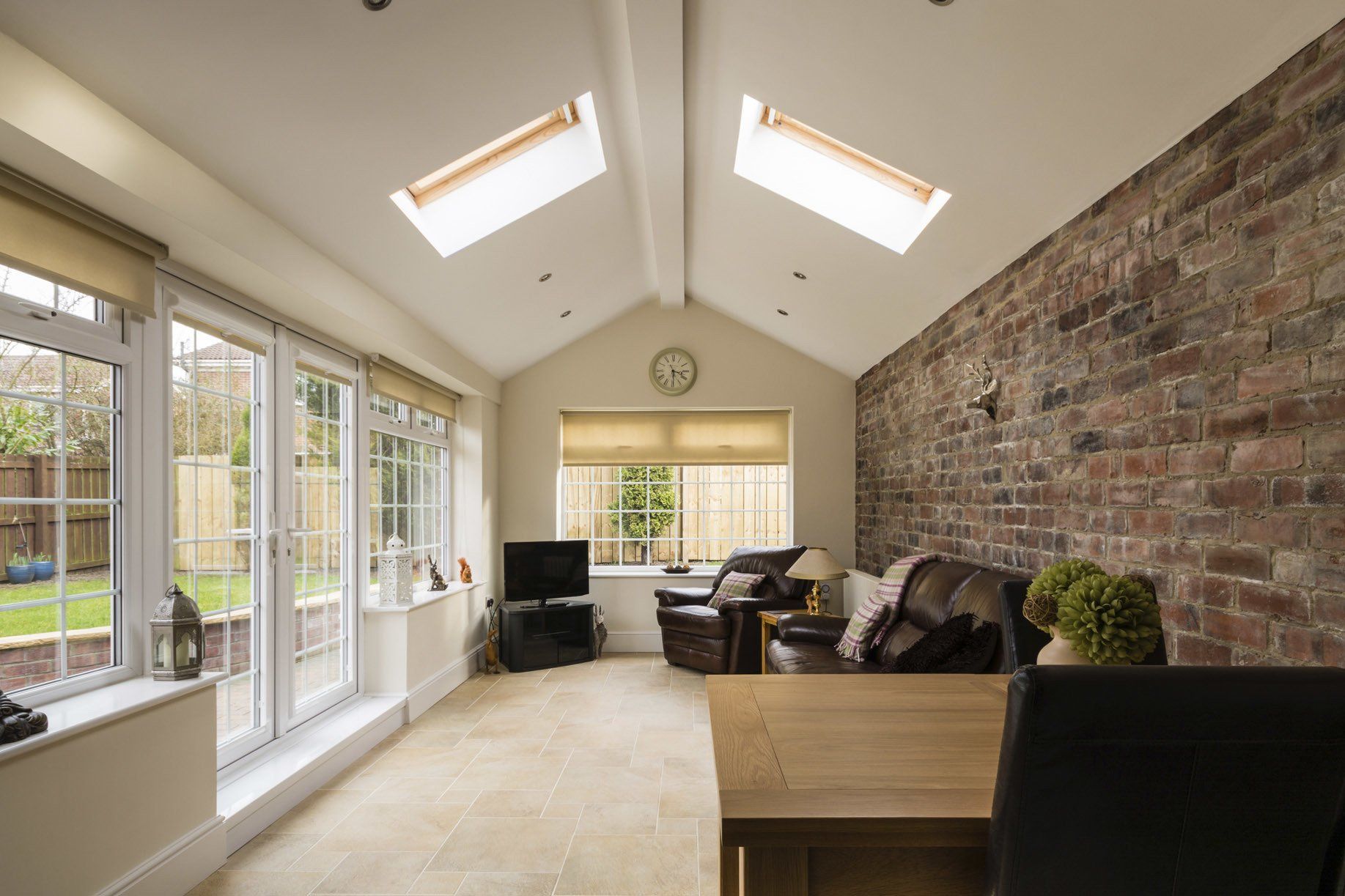 Sun Room — Modern Sunroom or Conservatory Extending into the Garden with a Featured Brick Wall in Clayton, NC