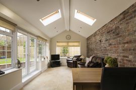 Sun Room — Modern Sunroom or Conservatory Extending into the Garden with a Featured Brick Wall in Clayton, NC