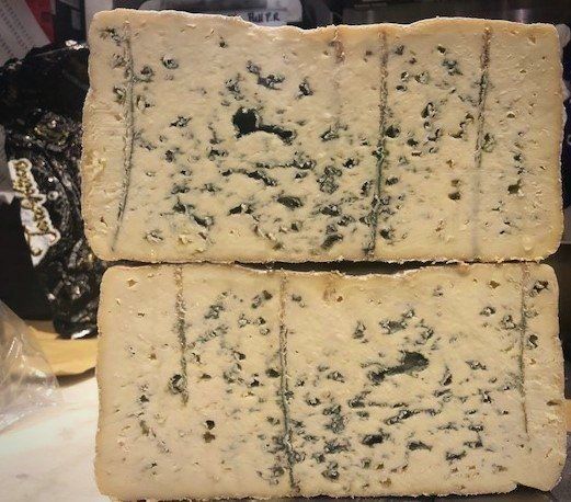 two pieces of blue cheese are stacked on top of each other