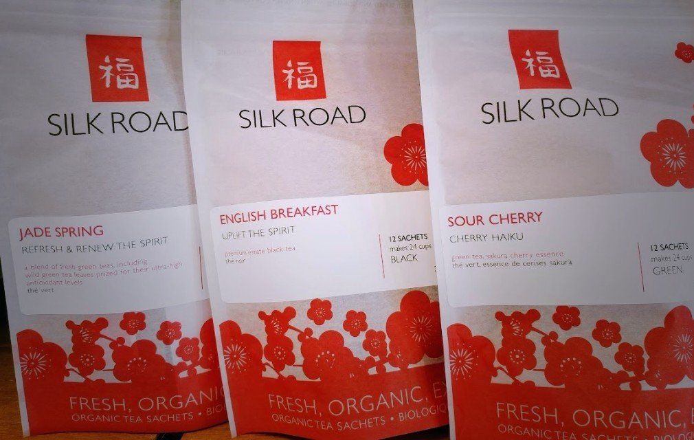 three bags of silk road tea sit on a table
