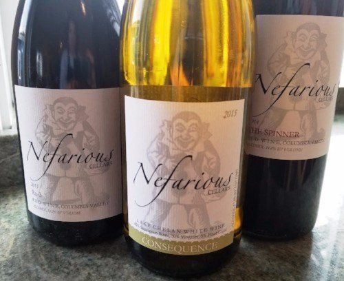 three bottles of nefarious wine are on a table