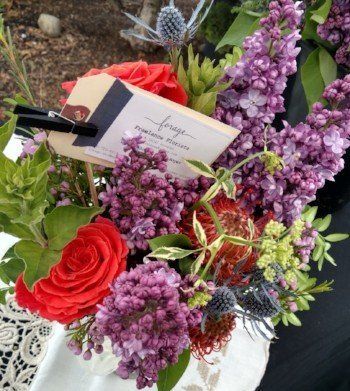 a bouquet of flowers with a name tag that says ' fringe ' on it