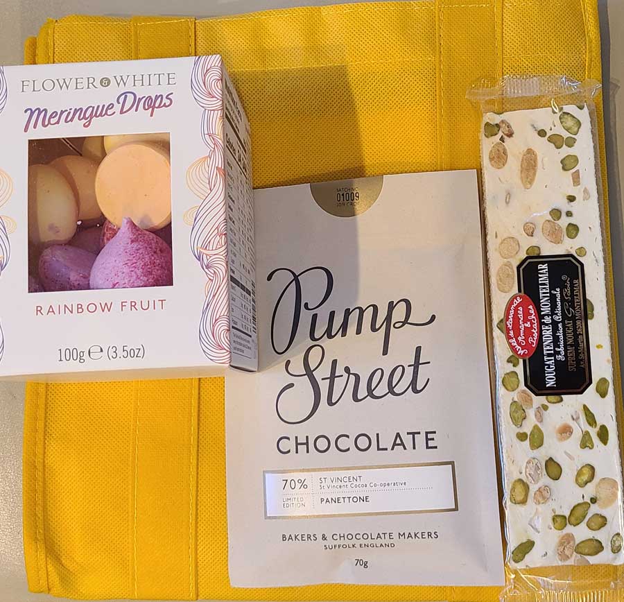 a box of pump street chocolate next to a box of meringue drops