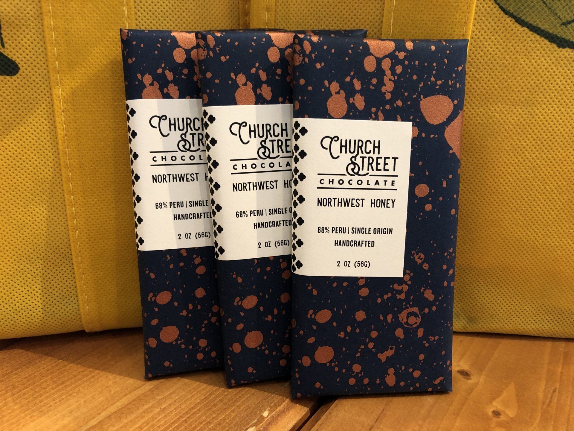 three bars of church street chocolate are sitting on a wooden table