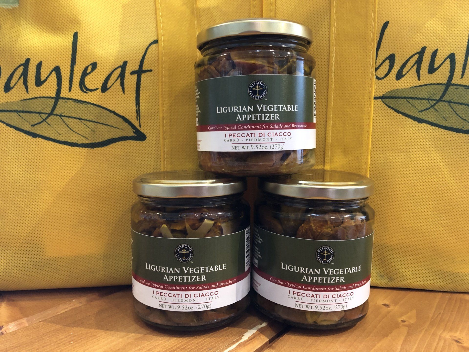 three jars of vegetable appetizer are stacked on top of each other