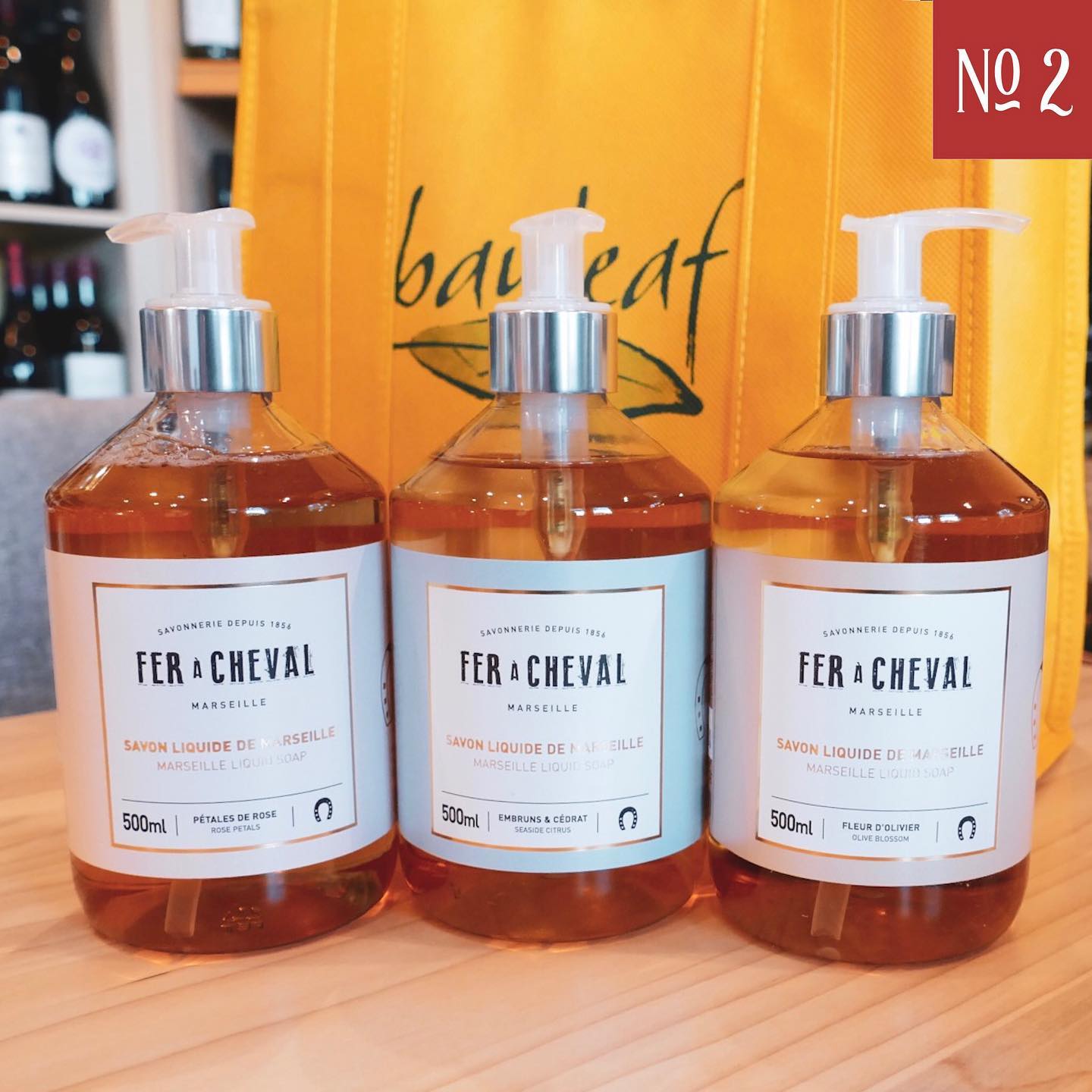 three bottles of fer cheval soap are sitting on a table