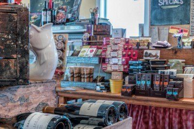 a table with bottles of wine and a piggy bank on it .