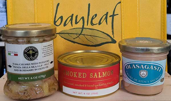 three jars of food are sitting next to each other on a table .