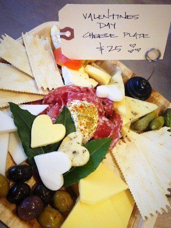 a valentine 's day cheese plate with hearts on it