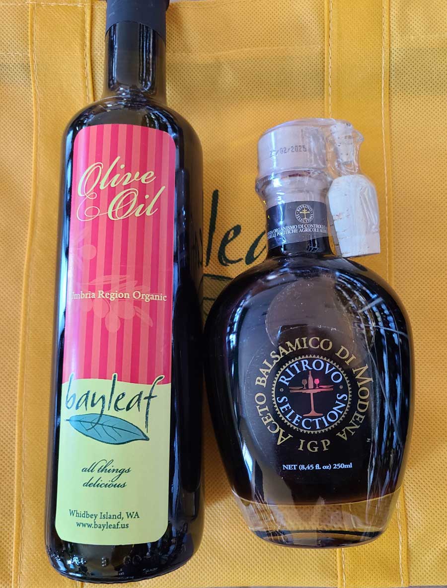 a bottle of olive oil next to a bottle of balsamic vinegar