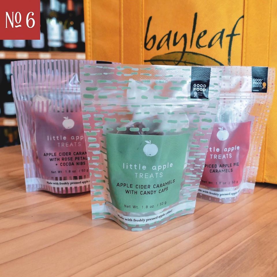 three bags of little apple treats are sitting on a table