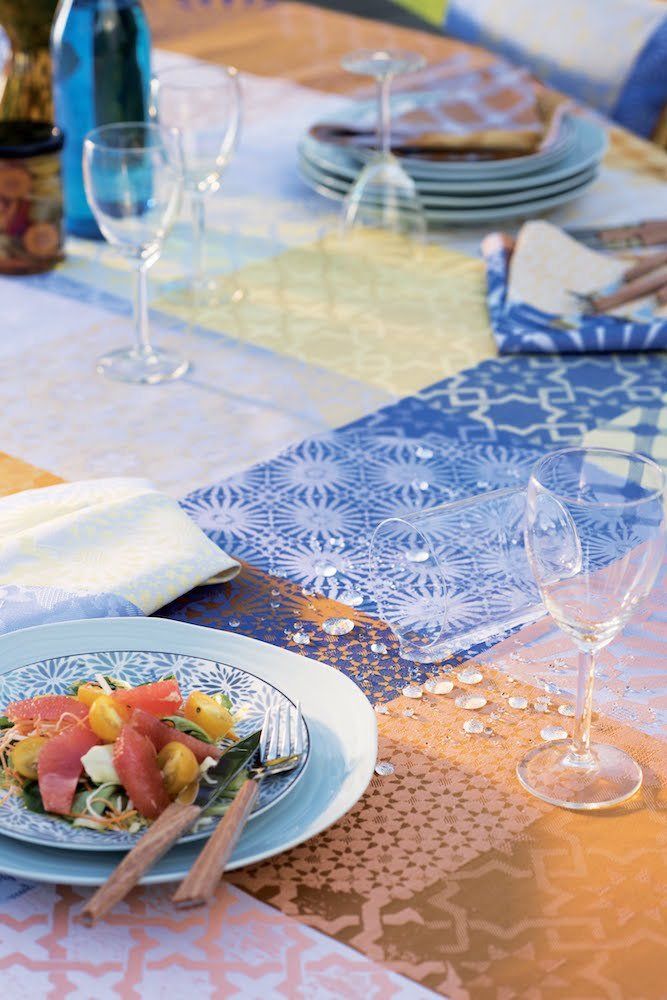 a table with plates of food and wine glasses on it .