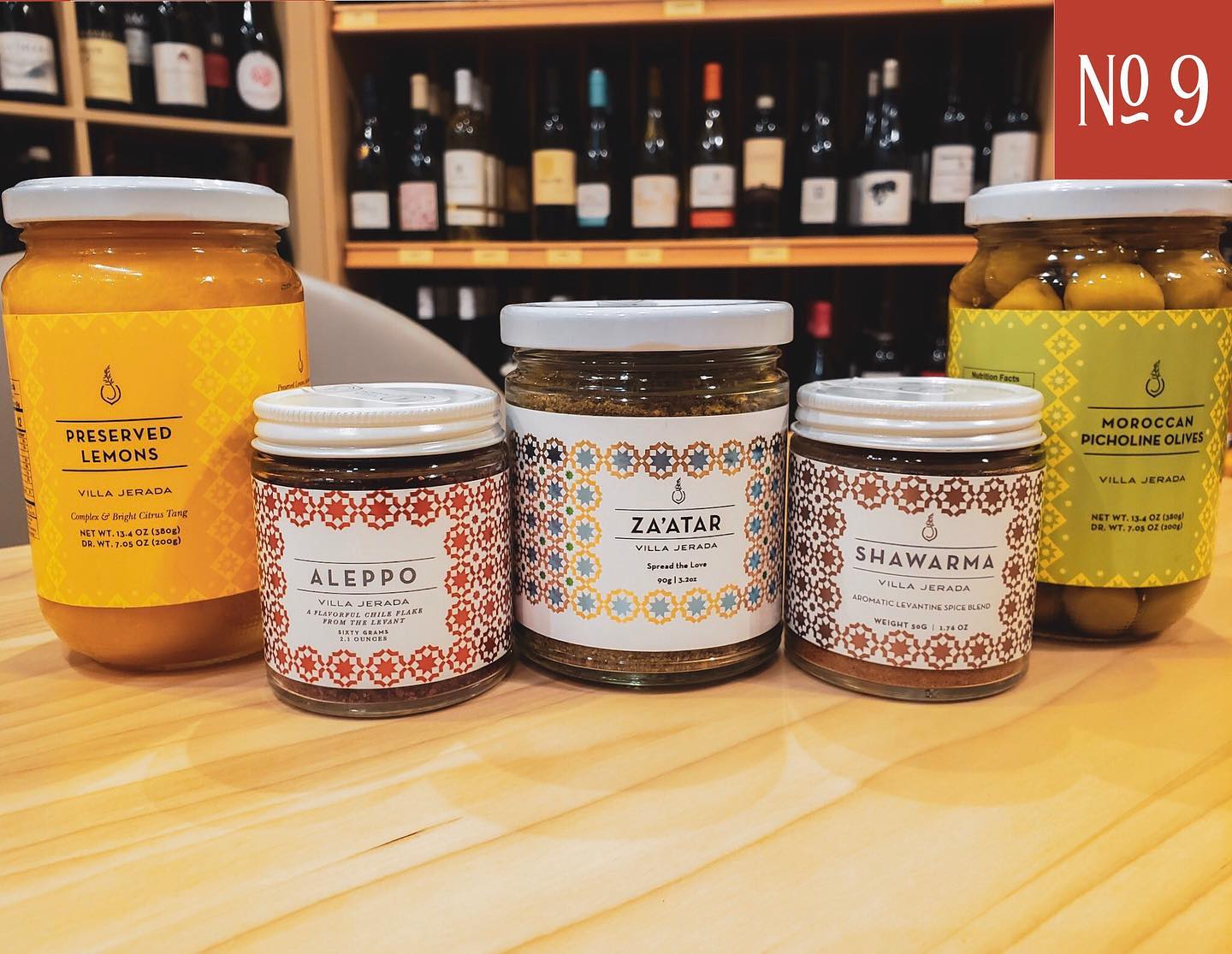 jars of food are lined up on a wooden table in front of a sign that says no 9