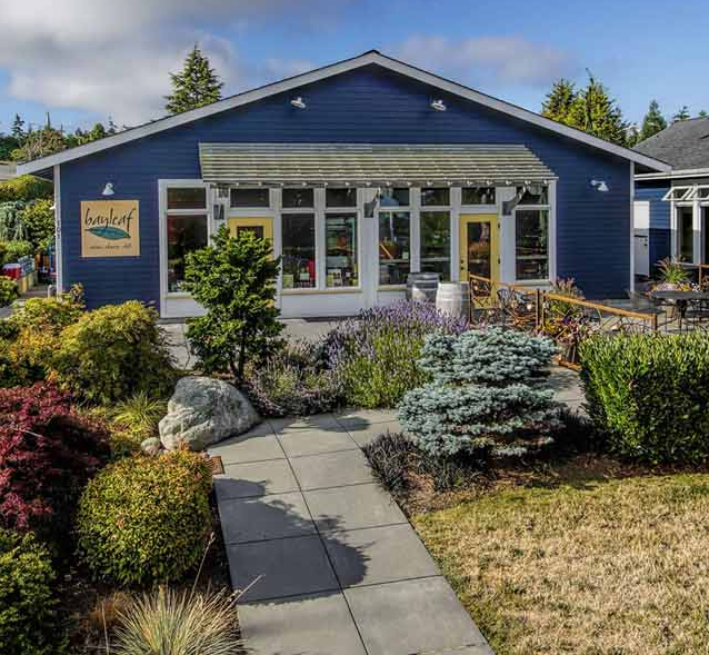 a blue house with a yellow sign that says ' sealeaf ' on it