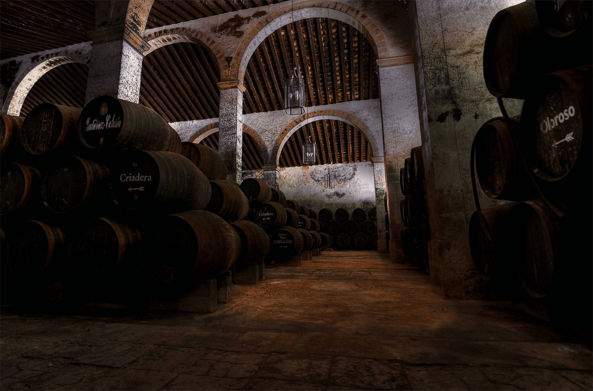 a warehouse filled with lots of barrels and bottles .