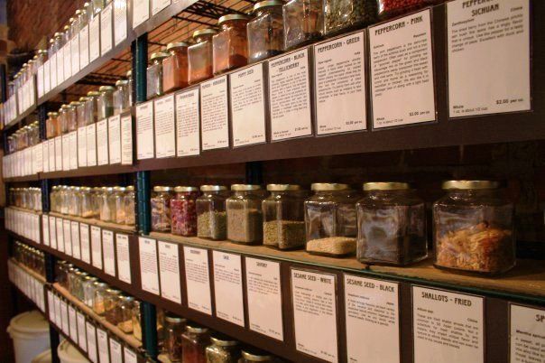 shelves filled with jars of various spices and herbs