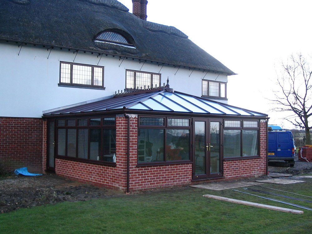 Grained effect UPVC with brick pillars attached to thatched roof property – Chediston, Halesworth, Suffolk