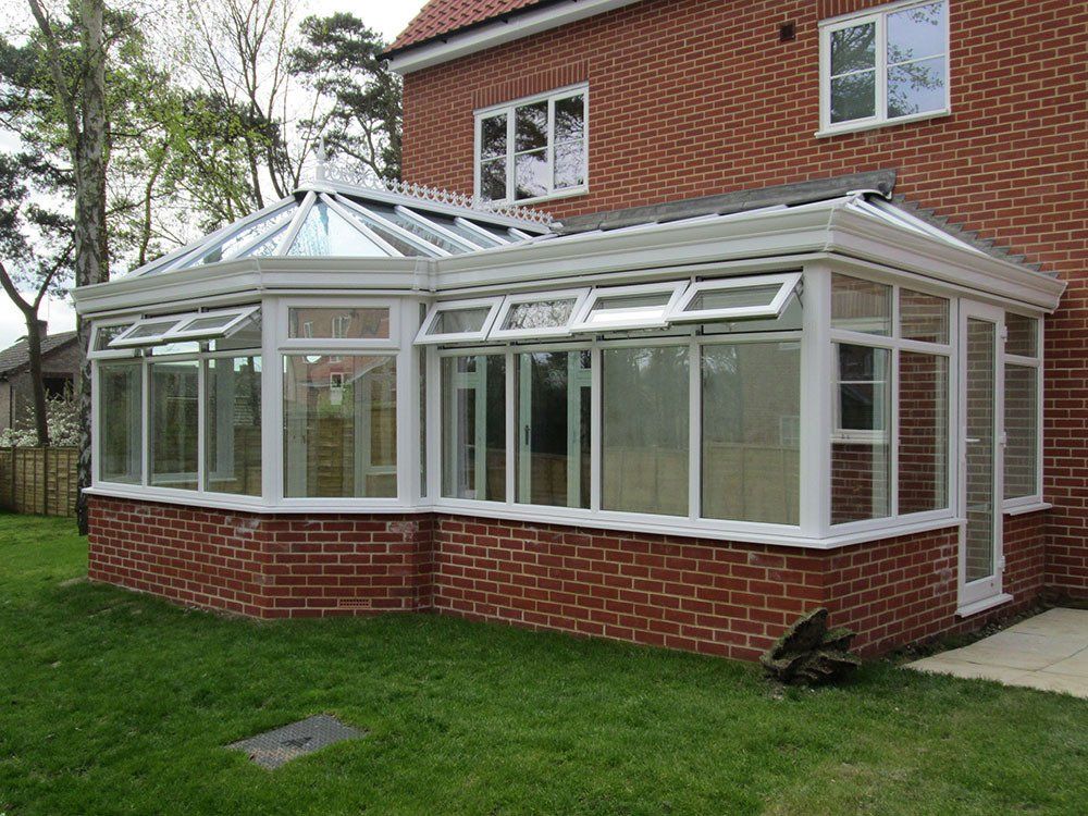 UPVC P-shaped conservatory with glass roof, dwarf wall and cornice guttering – Littleport, Ely, Cambridge