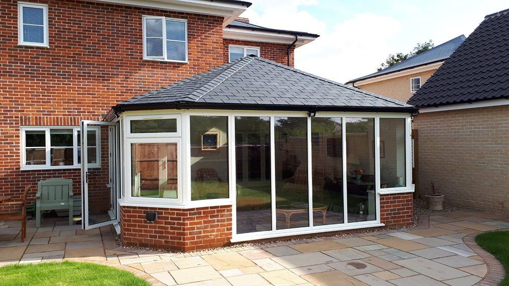 UPVC Victorian conservatory with Guardian Warm Roof and slate effect tiles