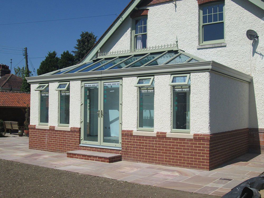 UPVC double-hipped orangery in Chartwell Green with cornice guttering – Halesworth, Suffolk