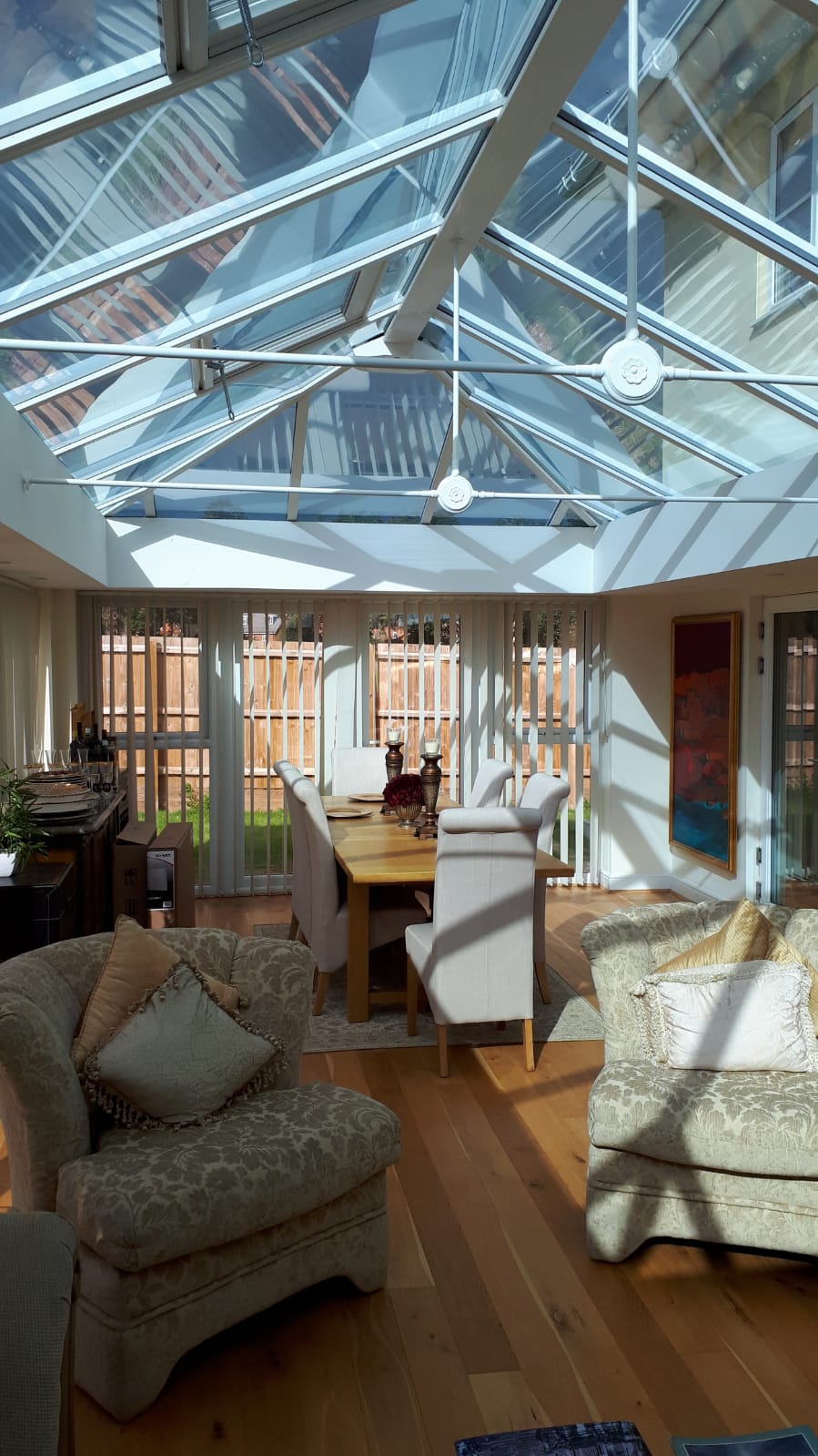 Internal view of UPVC double-hipped Edwardian fully glazed conservatory with Loggia corner posts, glass roof with vents and cornice guttering – Bury St Edmunds, Suffolk
