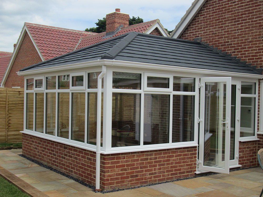 UPVC Edwardian conservatory, dwarf wall, Guardian Warm Roof and Metrolite tiles – Leiston, Suffolk