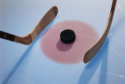 Puck between two Hockey Sticks — Team Uniforms in Philadelphia, PA Puck between two Hockey Sticks — Team Uniforms in Philadelphia, PA