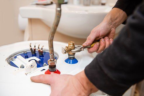 Worker Fixing Boiler Tubes — Odessa, TX — Stephen's Plumbing Heating & Air Conditioning Worker Fixing Boiler Tubes — Odessa, TX — Stephen's Plumbing Heating & Air Conditioning