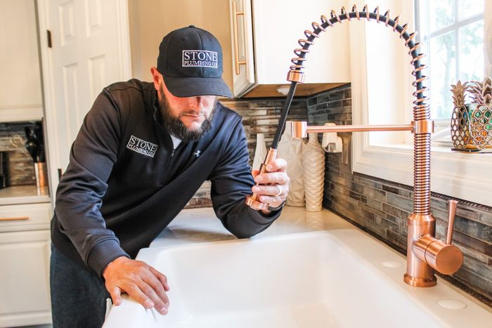 plumber fixing sink