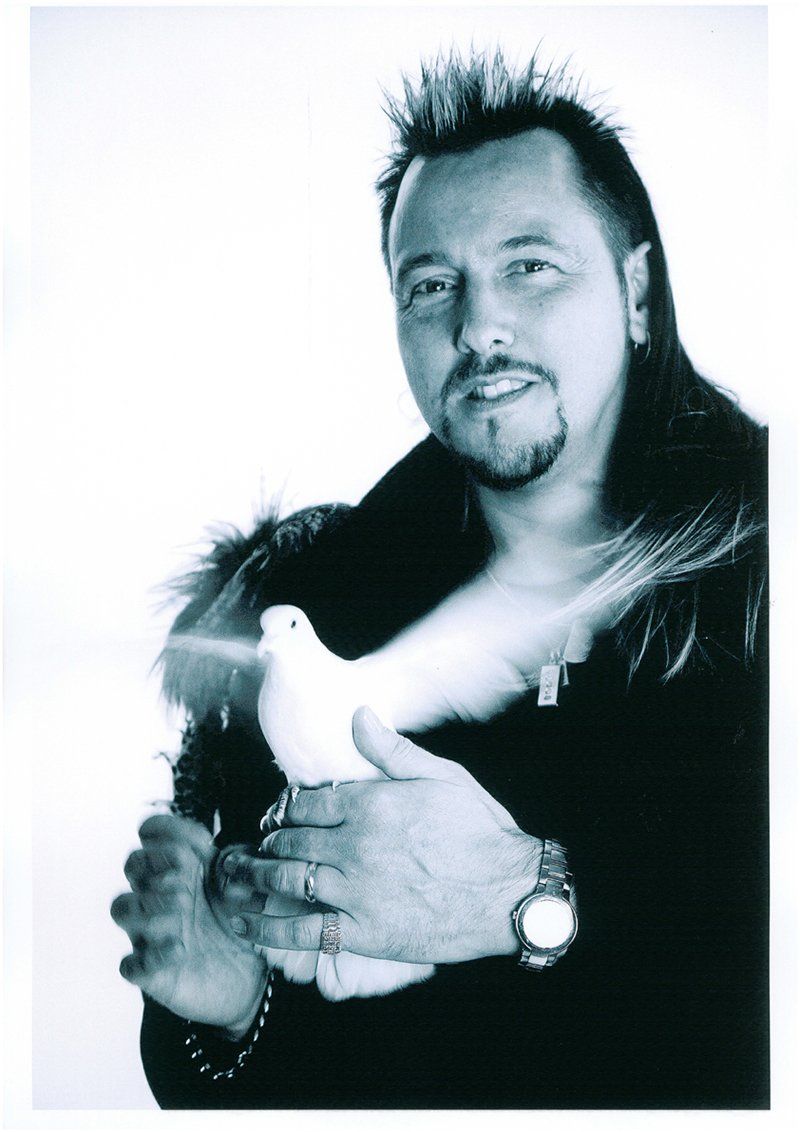 magician holding a white bird
