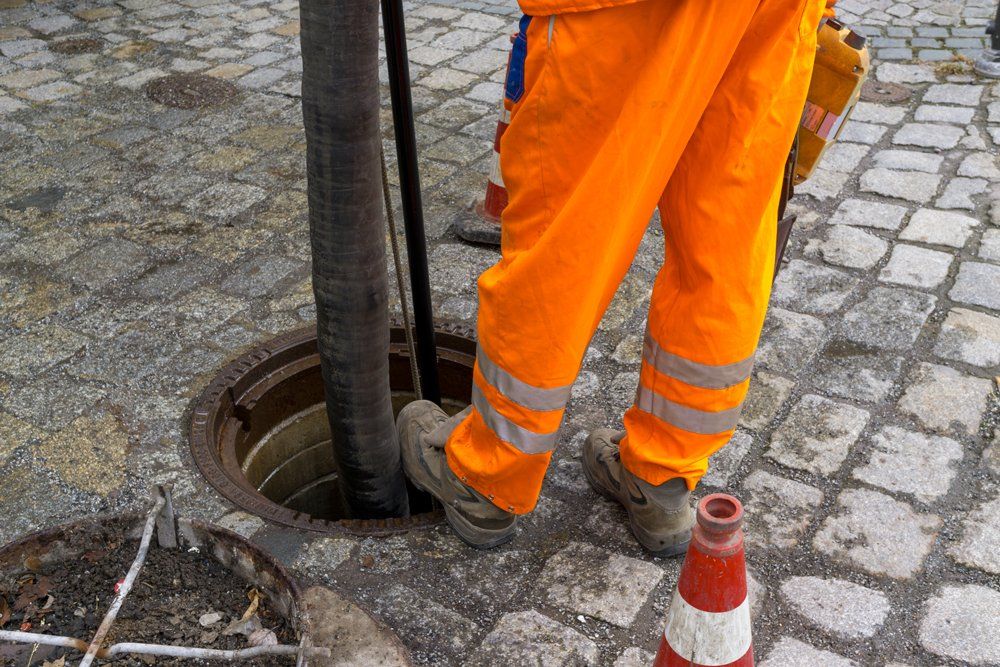 Septic Clean — Worker Cleaning Septic Pipe in Sterling, VA Septic Clean — Worker Cleaning Septic Pipe in Sterling, VA