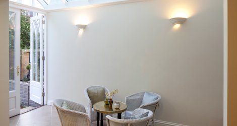 a newly installed conservatory with table and chairs for seating