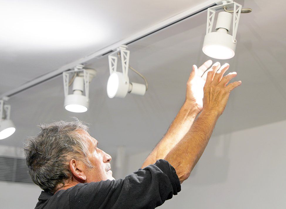 Man Fixing Ceiling Lights — Crossett, AR — Master Technicians & Mechanicals LLC