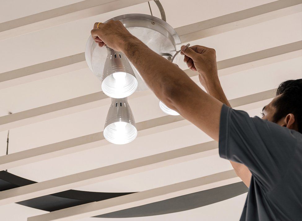 Man Fixing Ceiling LED Lights — Crossett, AR — Master Technicians & Mechanicals LLC