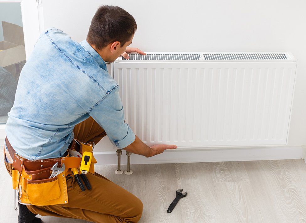 Technician Installing Heater — Crossett, AR — Master Technicians & Mechanicals LLC
