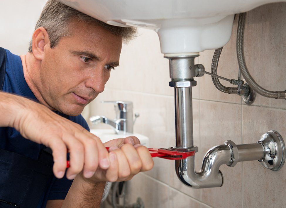 Plumber Repairing Bathroom Sink — Crossett, AR — Master Technicians & Mechanicals LLC