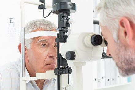 Optometrist doing sight testing for senior patient — Eye Care in Brick, NJ Optometrist doing sight testing for senior patient — Eye Care in Brick, NJ