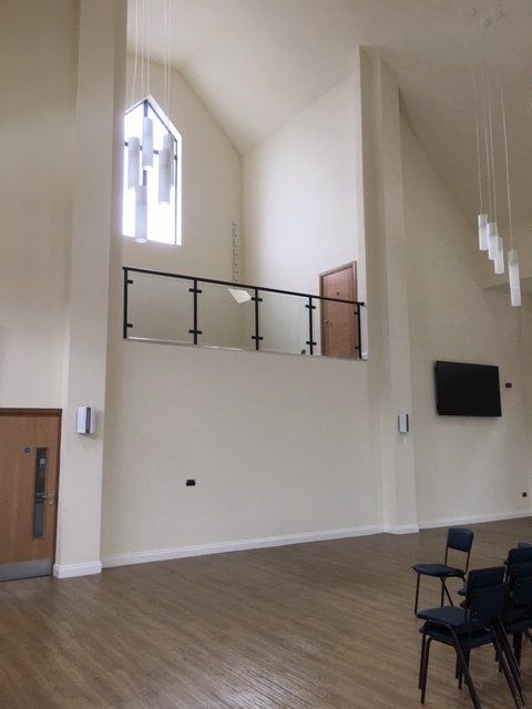 A large room with a balcony and chairs