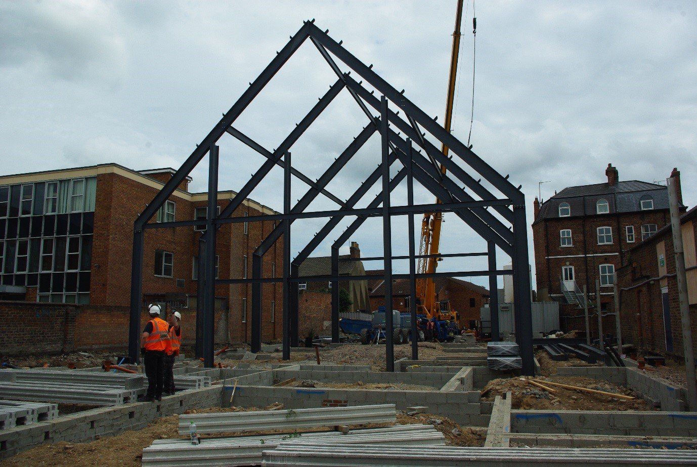 A building under construction with a crane in the background