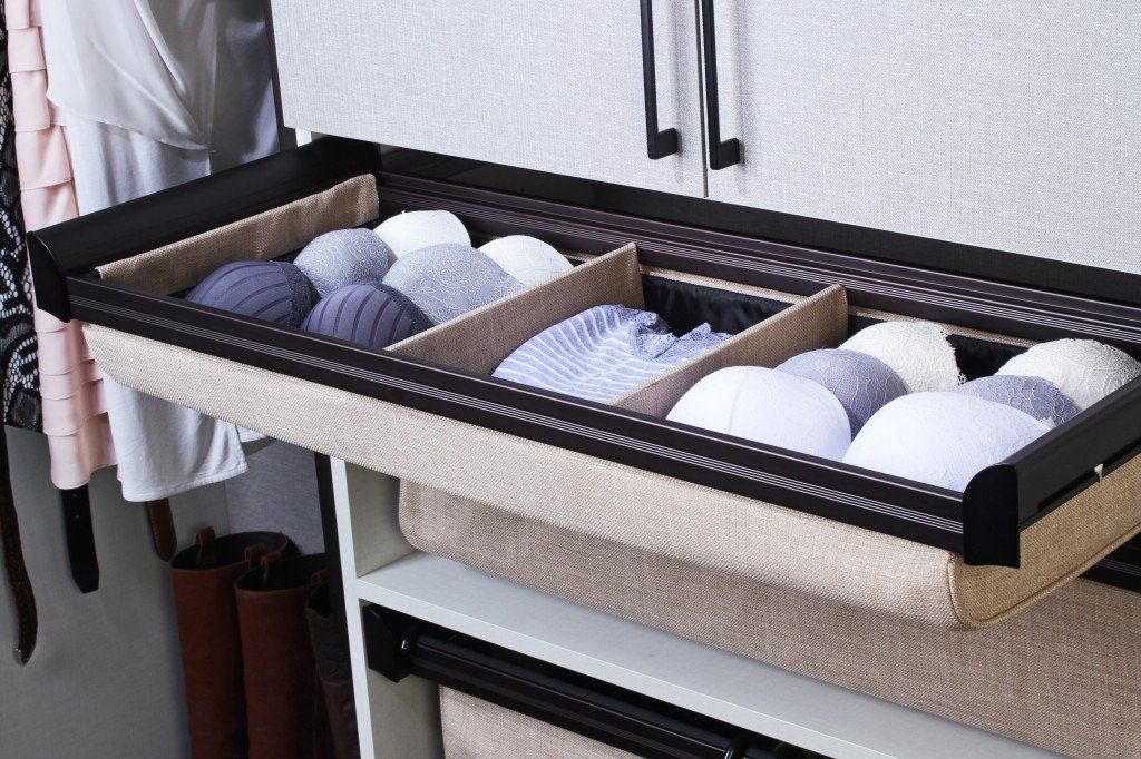 A drawer filled with socks and underwear in a closet.