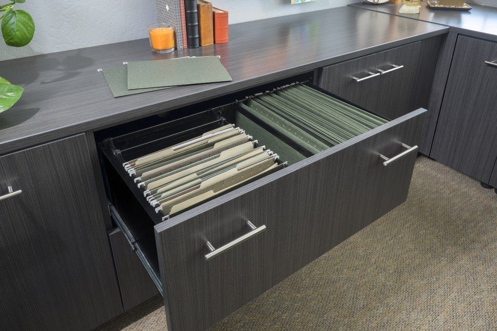 A drawer with a lot of files in it