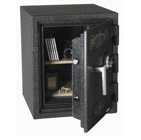 A black safe with the door open and a key in it.