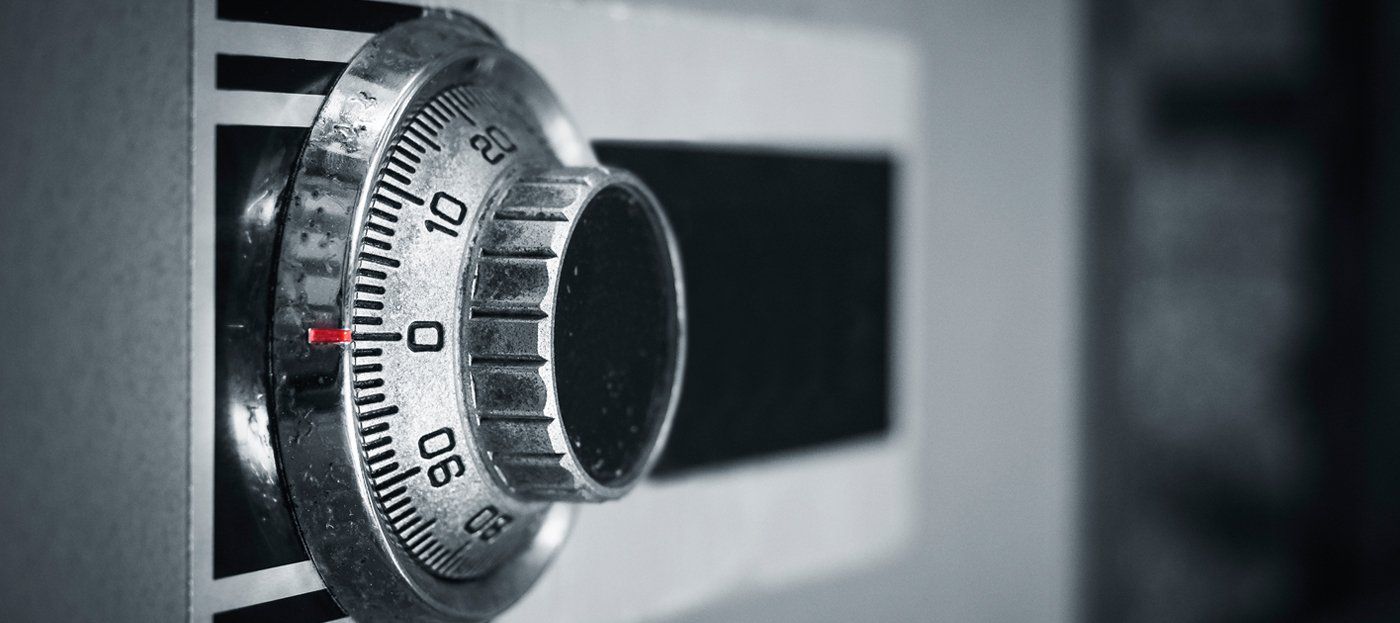 A close up of a combination lock on a safe.