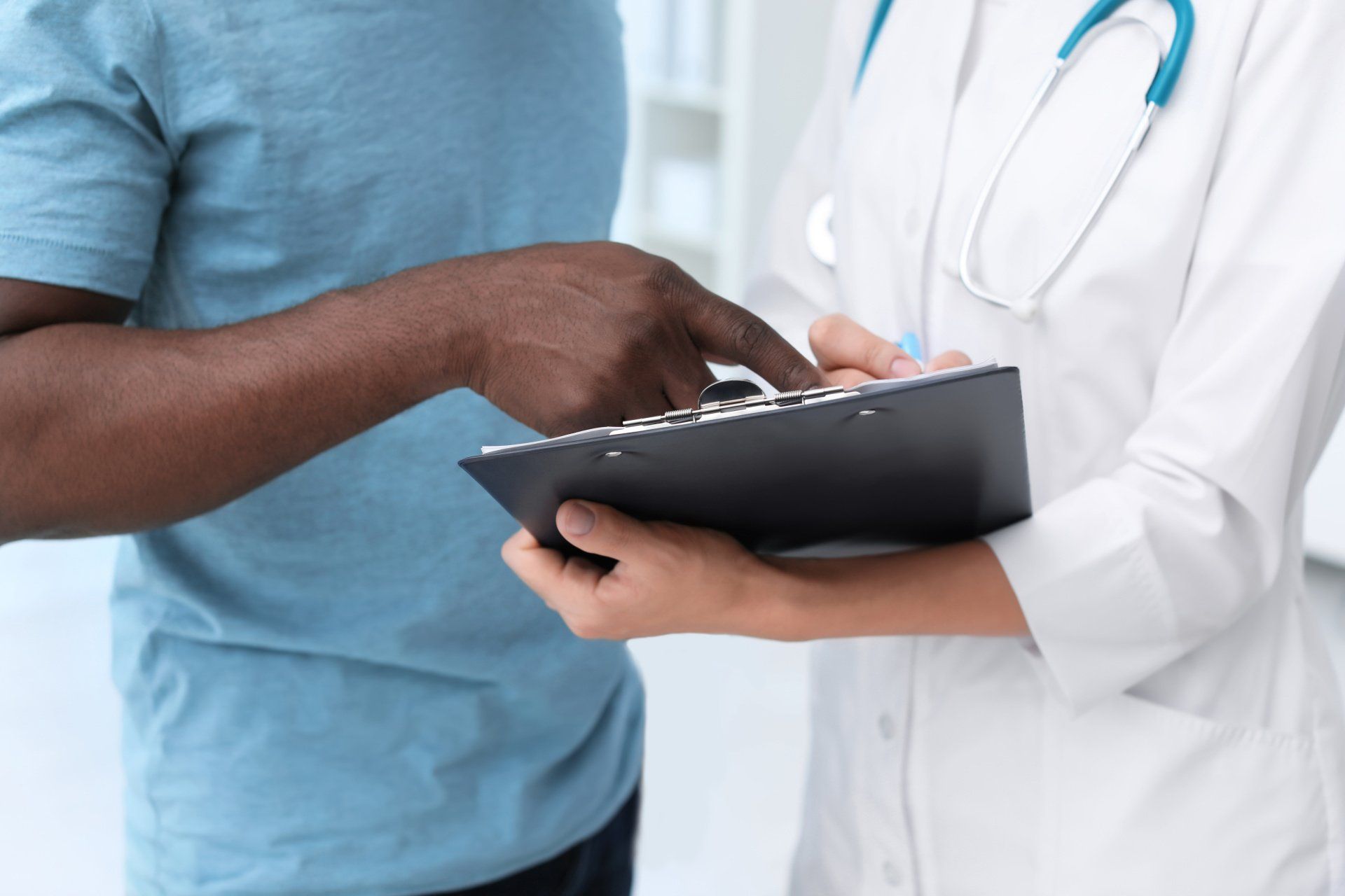 Doctor and Patient looking over clipboard