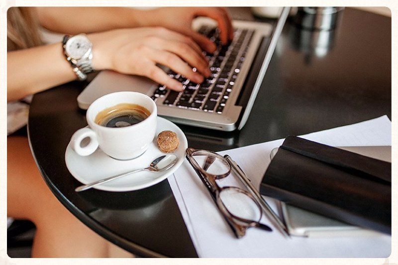 working hard on laptop coffee cup and wallet