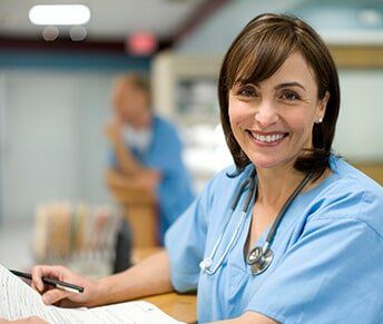 Female Doctor Holding Medical Records — Women's Clinic in Hialeah, FL Female Doctor Holding Medical Records — Women's Clinic in Hialeah, FL