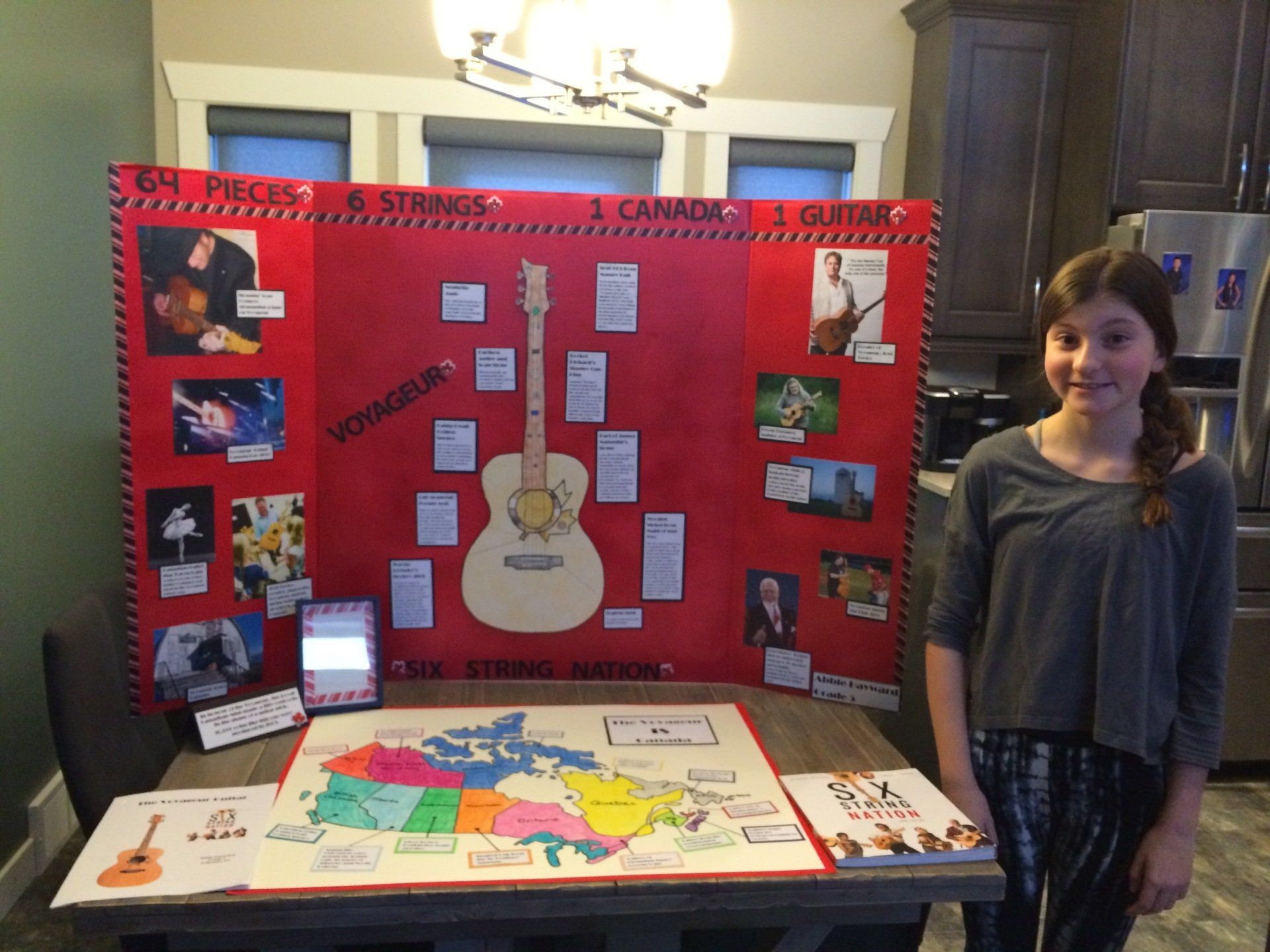 Student Abbie Hayward stands beside her award winning Heritage Fair project about Six String Nation.