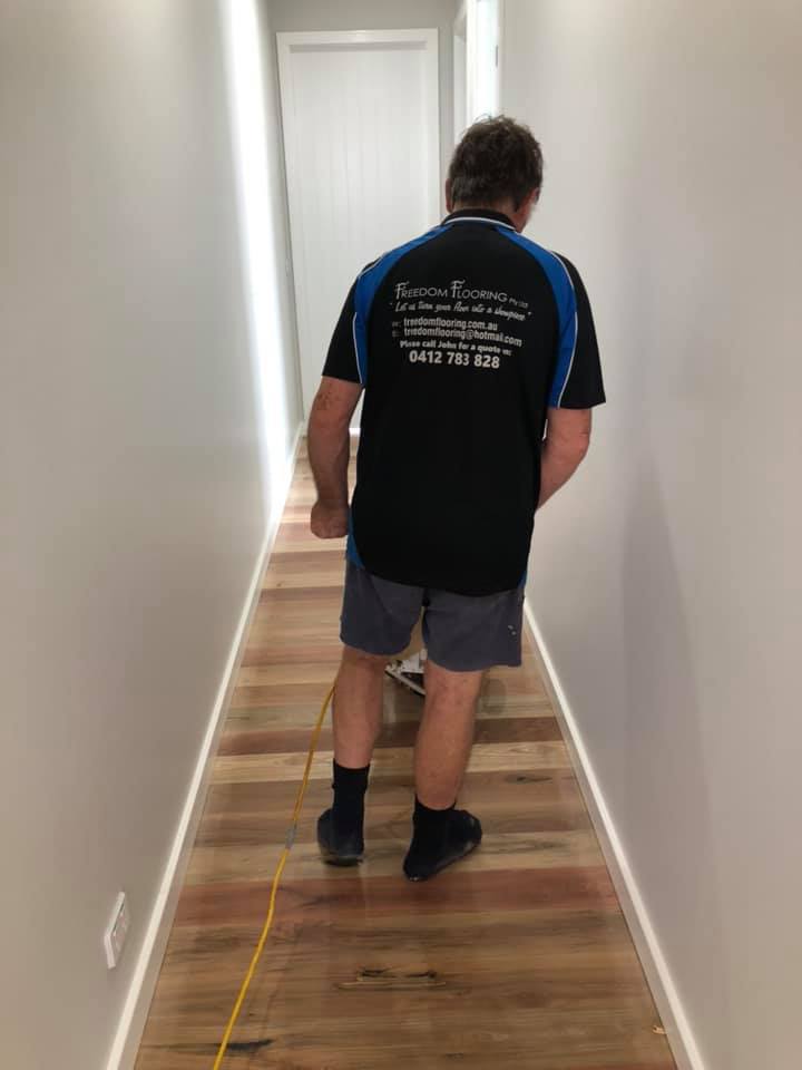 Worker Polishing Timber Flooring — Freedom Flooring Pty Ltd in Budgewoi, NSW